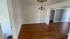 living room with white walls and wooden floor